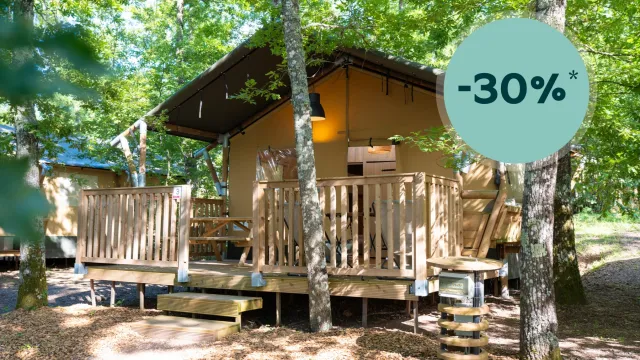 Cabin in lush forest with a discount badge in the corner.