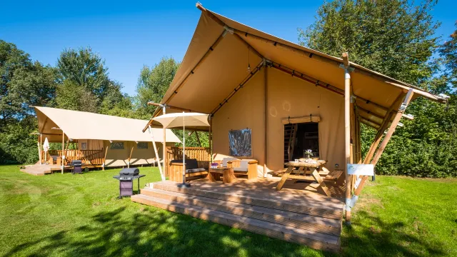 Glamping tent in an open green space