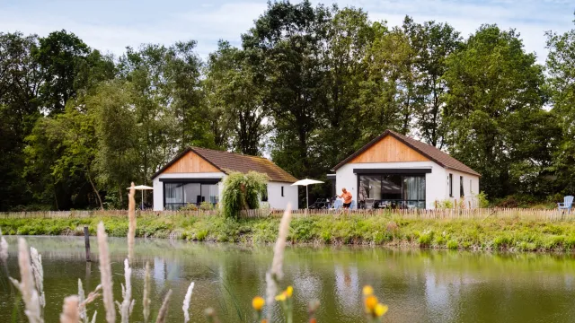 Two bungalows overlooking a fishing pond