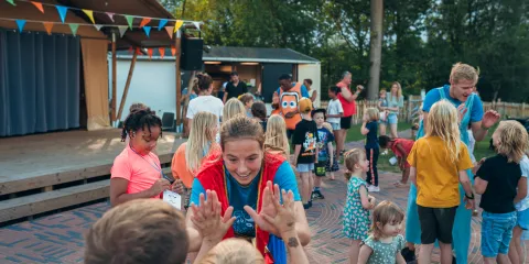 Outdoor gathering with children and adults playing games.