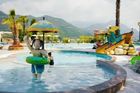A water park with a pirate ship slide and palm trees.