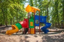 Colorful playground with slides and climbing structures in a park.