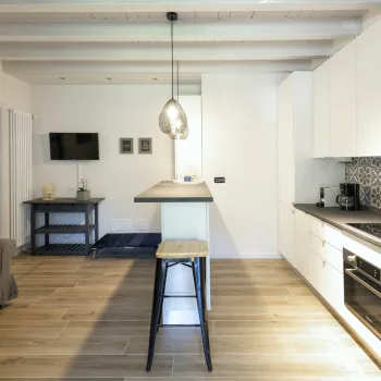 Open-plan kitchen and living area with modern decor and wood flooring.