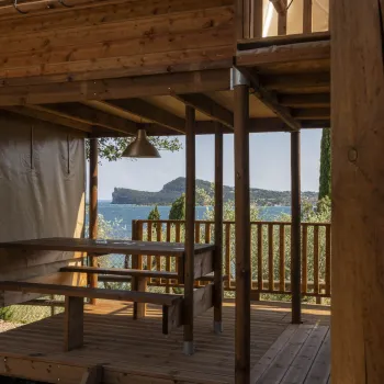Wooden terrace with bench, overlooking the sea.