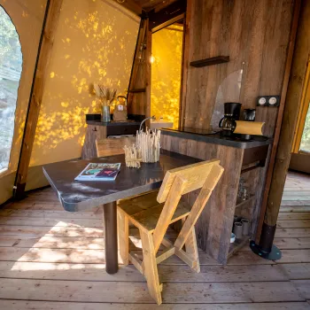 Cozy cabin interior with wooden furniture and warm lighting.