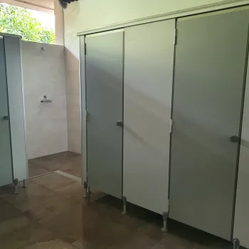 Public restroom with closed stall doors and tile flooring.