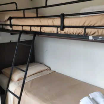 Bunk beds with bedding and towels.
