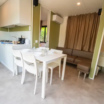 Modern kitchen with a dining table and a cozy lounge area.