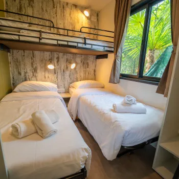 Cozy room with two single beds, window view.