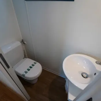 Second toilet, white sink.