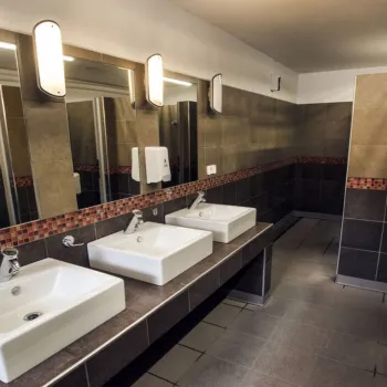 Modern restroom with sinks, mirrors.