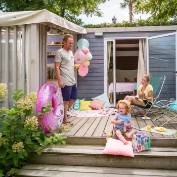 Family enjoying a sunny deck at the Cottage Clever