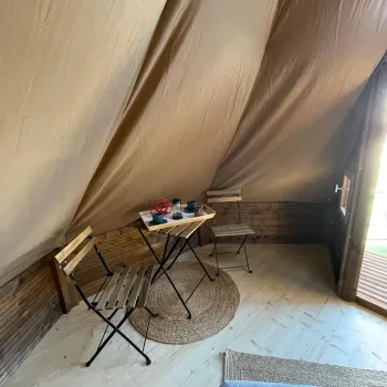 Inside of tipi tent with coffe table and chairs