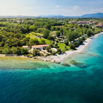 Aerial view of a coastline with turquoise waters and lush green landscape.