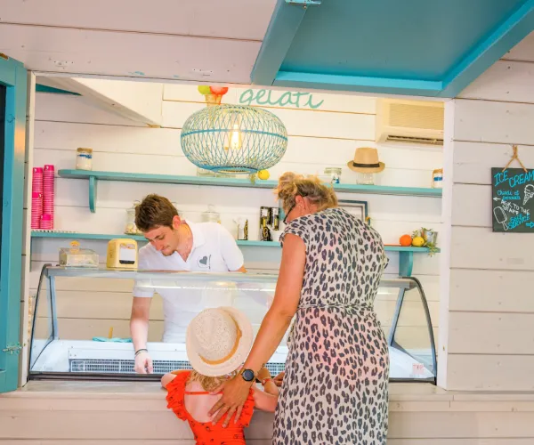 Ice cream shop with family ordering; bright, welcoming atmosphere.