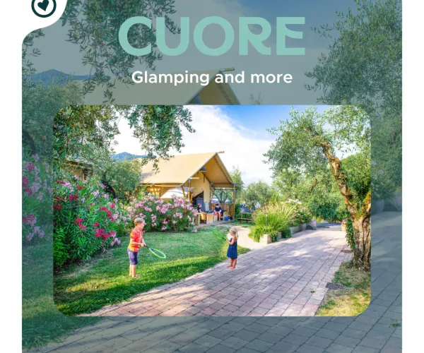 A family playing near a glamping tent surrounded by greenery.