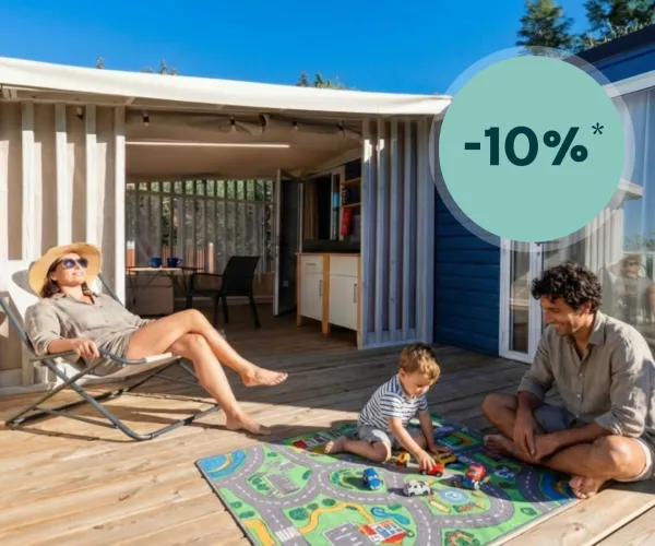 Family enjoying outdoor deck, child playing with toys on colorful mat.